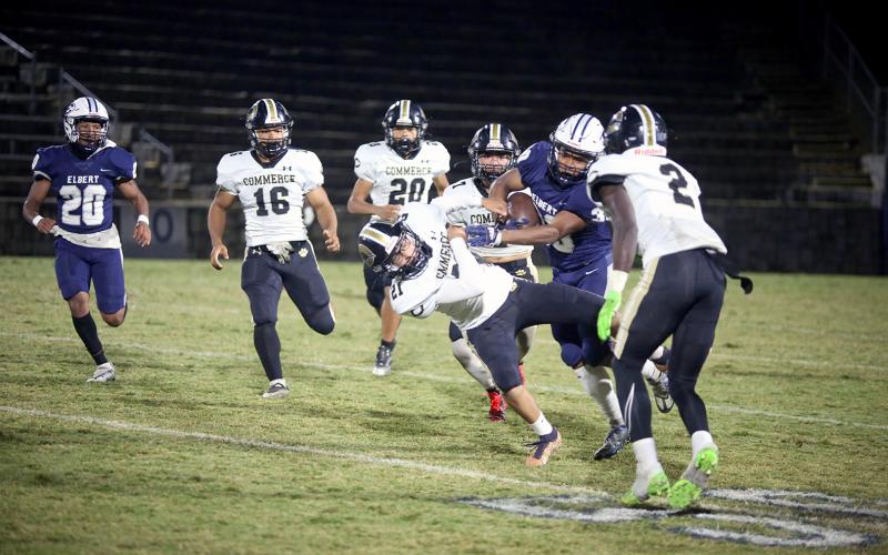 Miguel Rodriguez runs through a Commerce defender during a 34-yard return in Elbert’s win over Commerce Oct. 20. (Photos by Wells)
