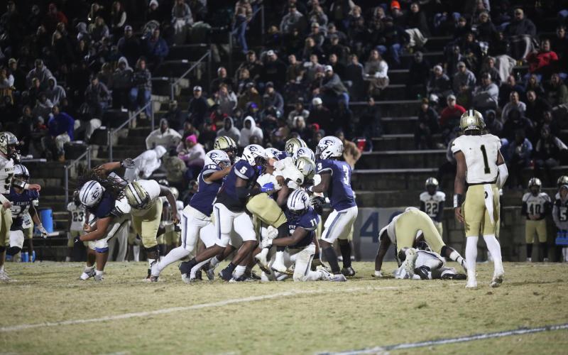 A host of Devils tackle a Swainsboro player during Elbert’s 34-28 loss to the Tigers Nov. 24. The loss brings Elbert’s season to a close after the Devils reached the 10-win mark for the second consecutive season. (Photo by Wells)