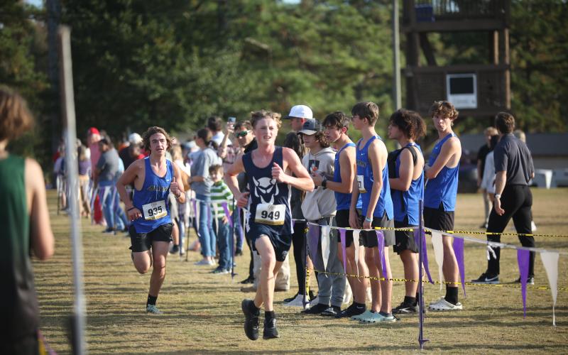 Ezra Adamson beats a Barrow runner to the finish line during the Region 8A Division 1 championship meet Oct. 26. (Photo by Wells)