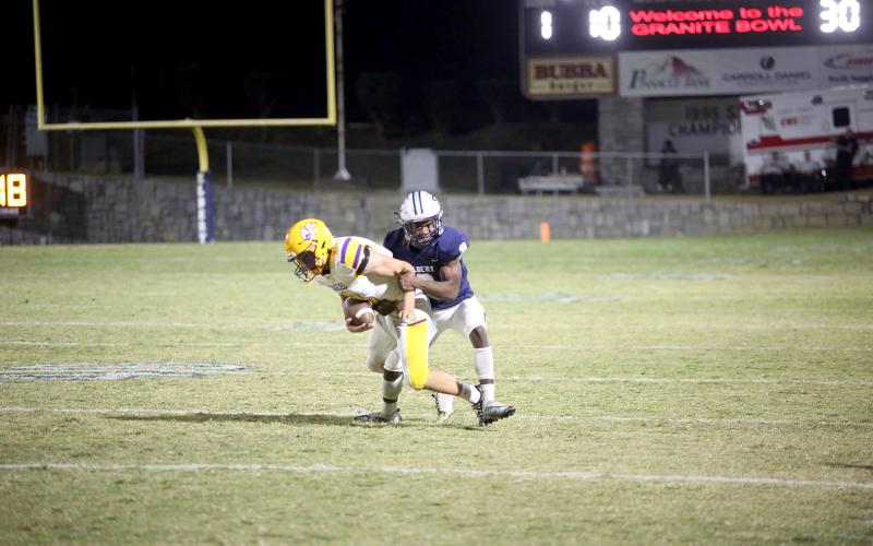 Senior Isiah Davis makes an open-field tackle on the Athens Christian quarterback. (Photo by Wells)