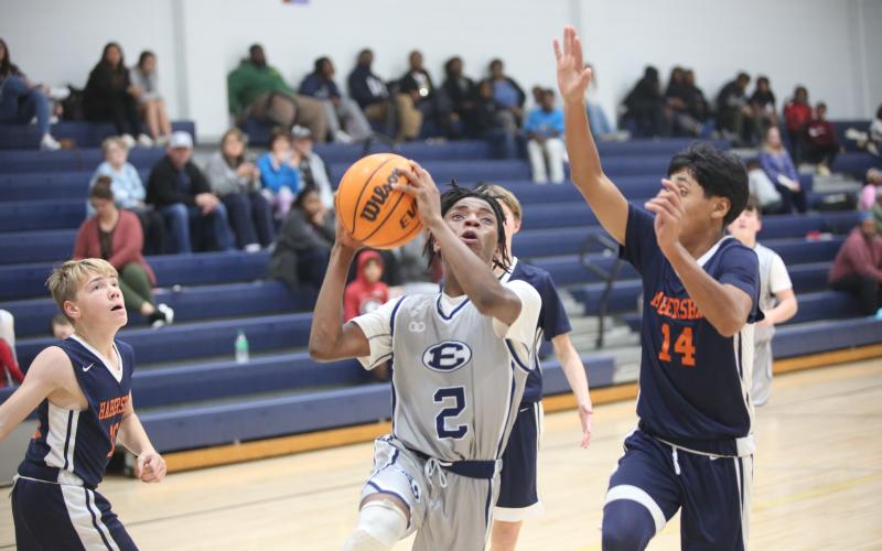 Tyler Turman splits a pair of Habersham defenders and drives to the basket Dec. 11. (Photo by Wells)