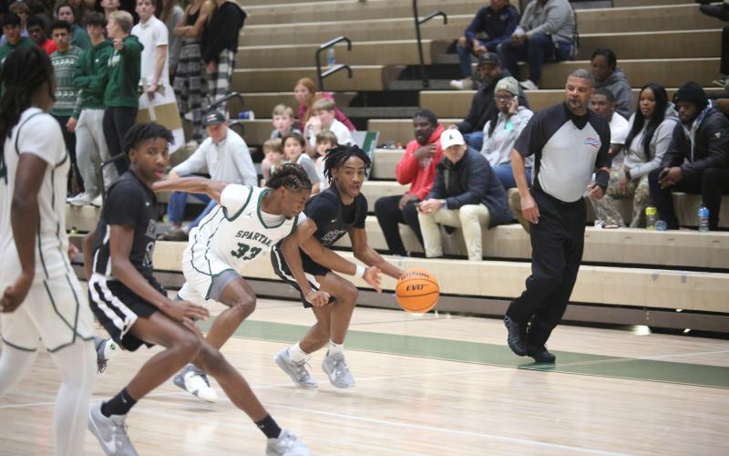 Tank Givens dribbles past an Athens Academy defender during Elbert’s loss to the Spartans Dec. 8. (Photo by Wells)