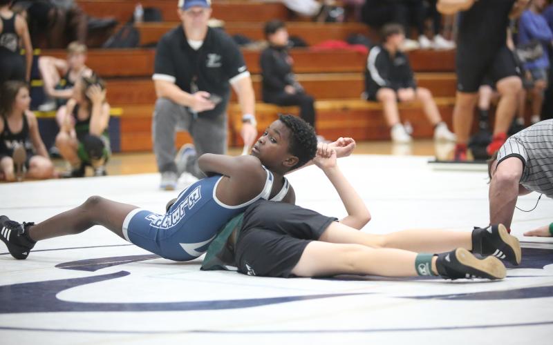 Ny’Zaevion Merriett looks to his coaches as he attempts to pin a Youth Middle School wrestler during Elbert’s exhibition matches. (Photo by Wells)