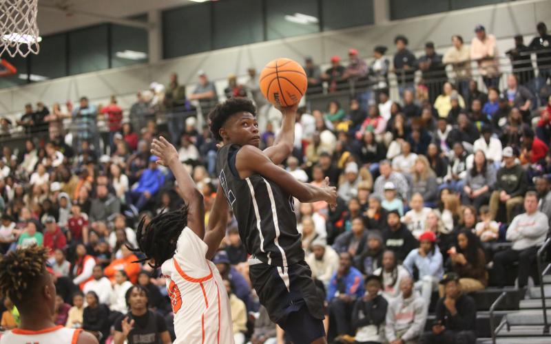 D.K. Winn floats in the air as he attempts a reverse layup in Elbert’s loss to Hart County. (Photo by Wells)