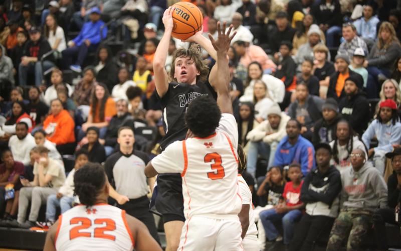 Grady Jones rises over a Hart defender to get off a three-point attempt in the game against Hart. (Photo by Wells)