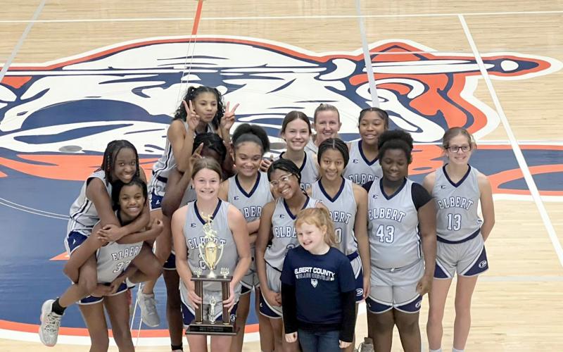 The seventh grade Lady Rams team poses with their championship trophy after defeating Madison County 34-30 Jan. 20. (Photo courtesy of Donna Baker))