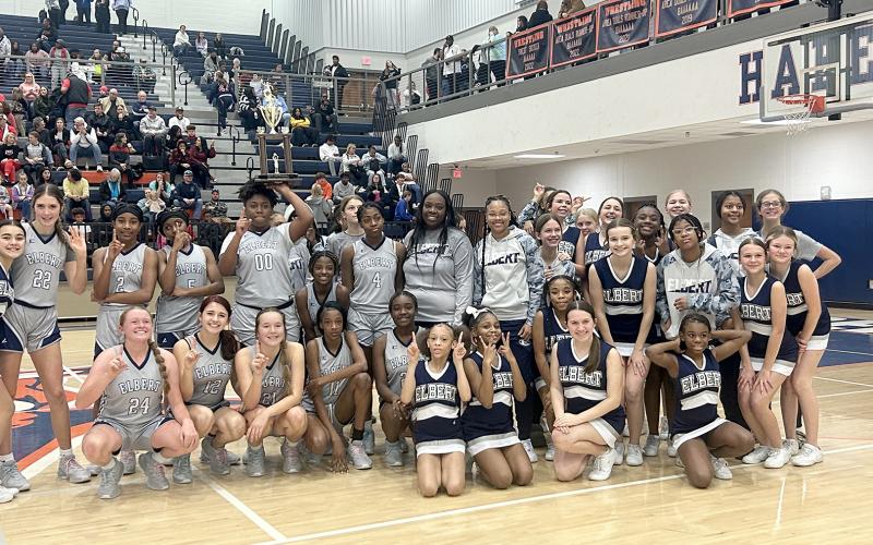 the eighth grade Lady Rams, seventh grade Lady Rams and ECMS basketball cheerleaders pose with the eighth grade championship trophy Jan. 20. (Photo by Wells)