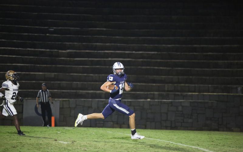 Brady Dickerson looks to the Elbert sideline as he runs into the endzone during Elbert’s win over Jefferson County Sept. 22. (Photo by Wells)