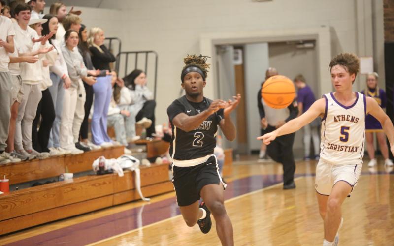 Boaz Goodman passes to a teammate during Elbert’s game against Athens Christian Jan. 12. (Photo by Wells)