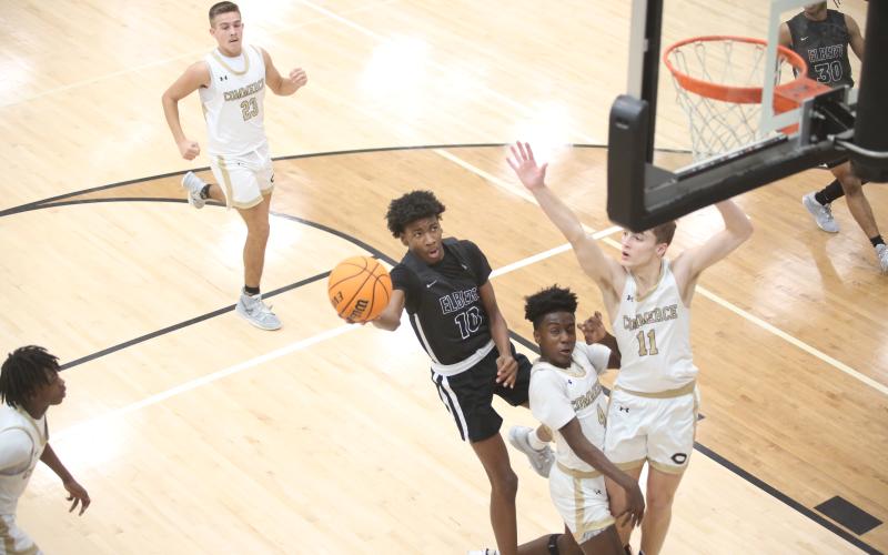 A.J. Brown takes on two defenders and lays the ball in at the end of a fast break during Elbert County’s 59-55 win over Commerce Feb. 2. Brown led the team in scoring with 14 points. (Photo by Wells)
