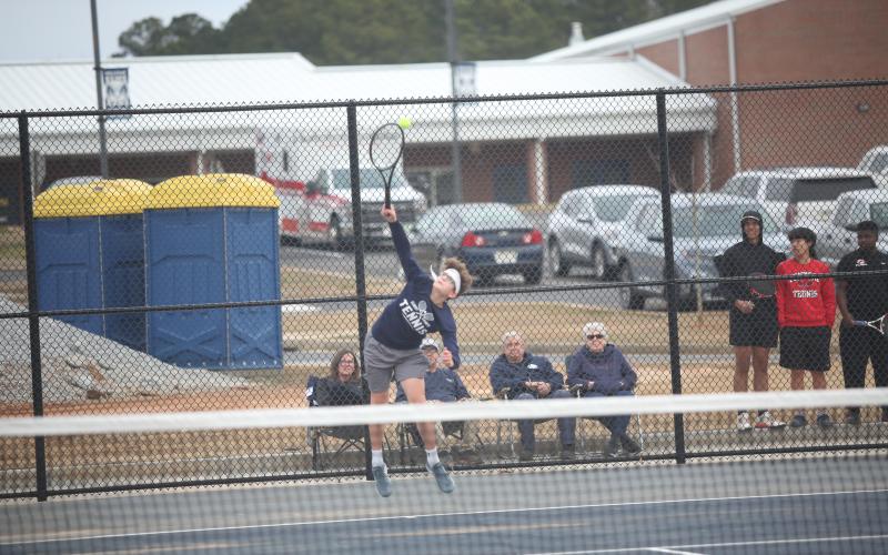 Ty Johnson serves the ball during Elbert’s first home match of the season against Clarke Central Feb. 8. (Photo by Wells)