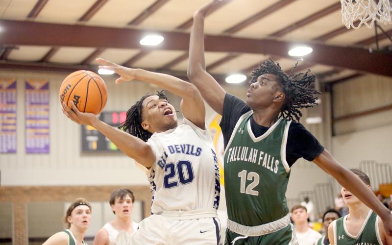Landon Hill goes up with the ball in front of a Tallulah Falls defender during Elbert’s win over the Indians in the Region 8A Division 1 tournament. The Devils finished in third place during the tournament behind a team-high 20 points from Hill. (Photo by Wells)