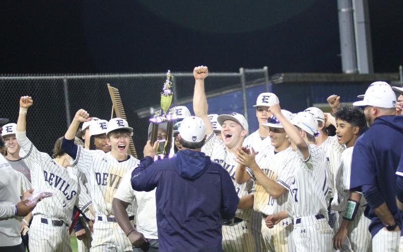 Head Coach Lance Ingram presents the Devils with the region championship trophy after they clinched the region with a win over Commerce last season. This year’s Diamond Devils team started the year ranked in the Top 10 in Class A Division 1 and are 1-0 in region play after a win over Tallulah March 4. (File photo by Wells)