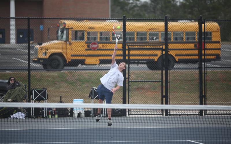 Adrian Jenkins serves the ball during his 9-7 win over his Hart County opponent in the No. 1 singles match. (Photo by Wells)