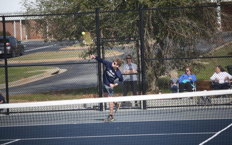 Mitchell Wheeler serves the ball during the Devils 3-2 win over Barrow Arts and Sciences Academy March 11. (Photo by Wells)