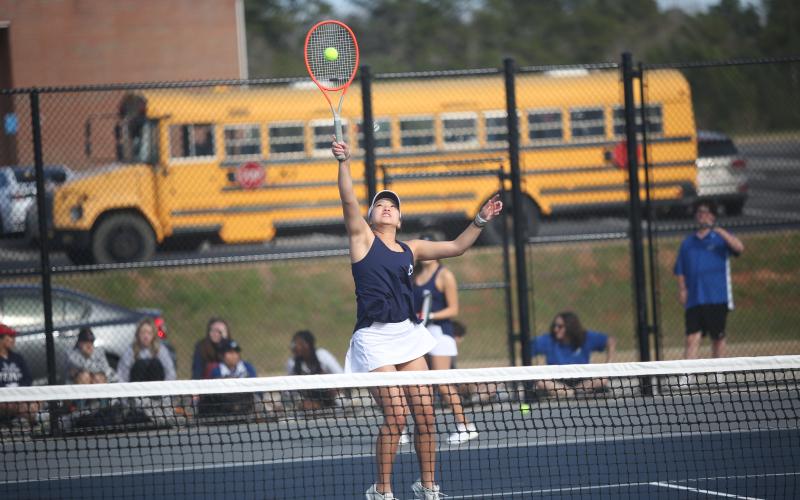 Myla Warwick defends the net as she leaps for a shot in the Lady Devils’ 5-0 sweep of  Barrow. (Photo by Wells)