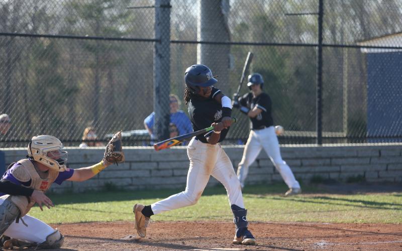 Cheyvis McLendon makes contact with the ball during Elbert’s first game against Athens Christian March 29. (Photo by Scoggins))