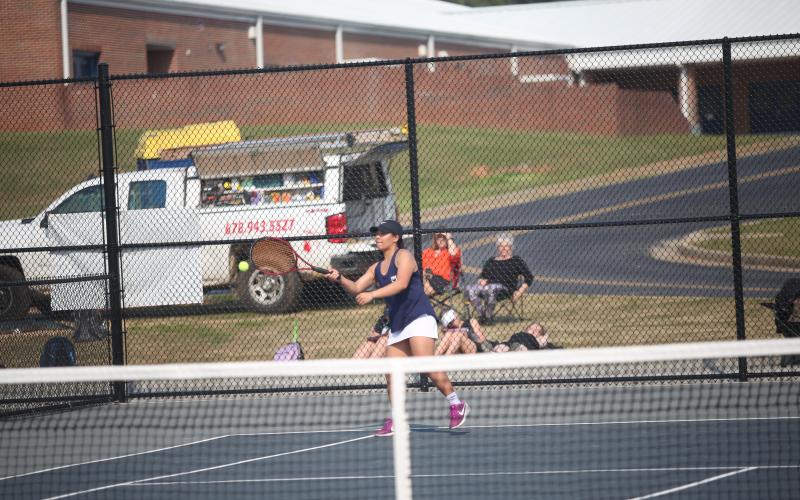 Lady Devil senior Katie Nguyen returns a serve during a March 21 match against Hart County. The Devil and Lady Devil seniors were recognized prior to the start of this year’s region tournament. (File photo by Wells)