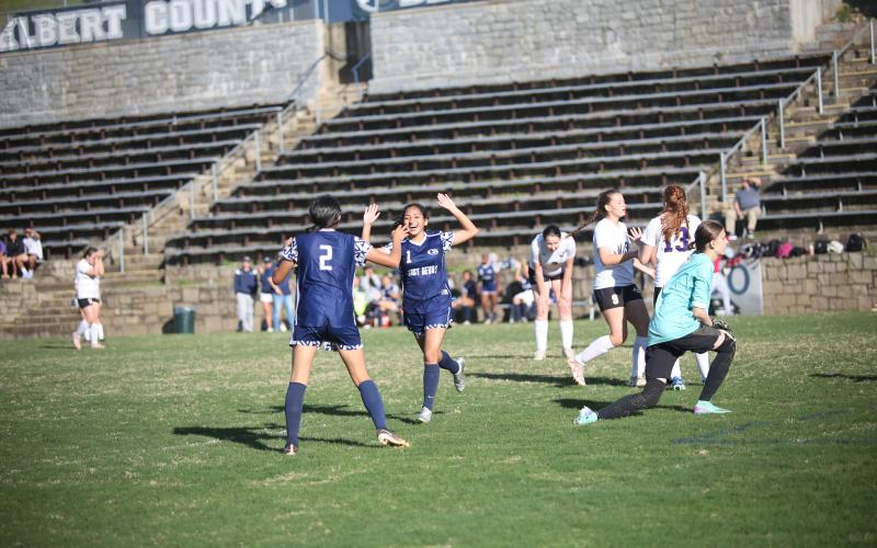No. 1 Vivian Salazar celebrates with No. 2 Allison Medina after scoring a goal during Elbert’s win over Athens Christian. (Photo by Wells)