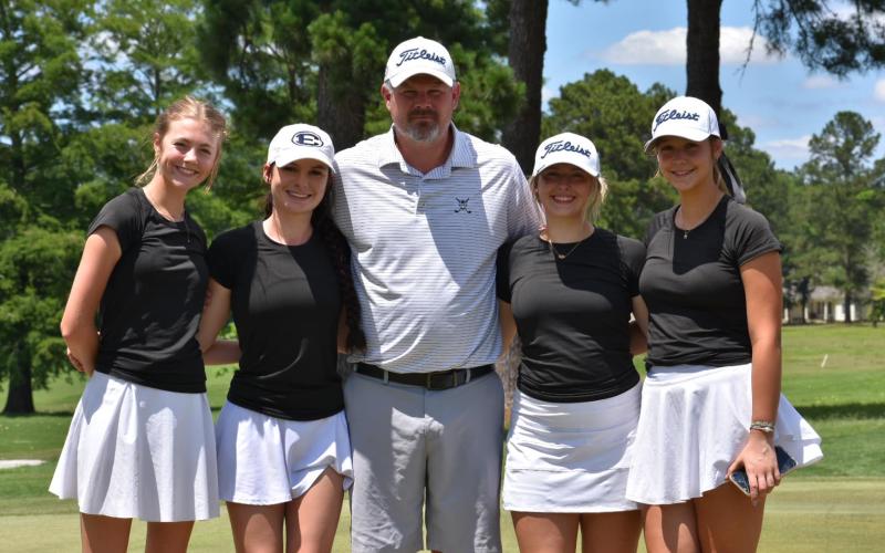 (L-R) Camdyn Moon, London Blackmon, Head Coach Larry Kesler, Ellie Wheeler and Lucy Johnson pose for a team picture during the state championship tournament.