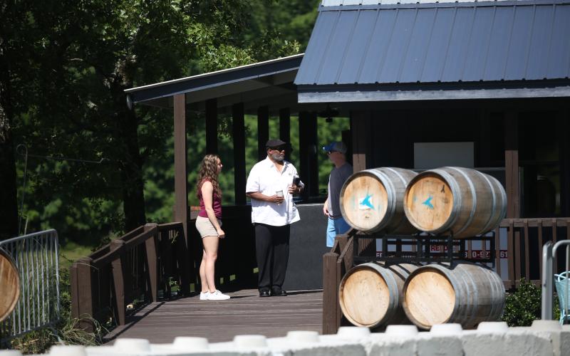 Katie Brannen and Joseph Norman talk with Elbert County Comprehensive High School Art Teacher Lee Wells during the event at Beaverdam Marina. (Photo by Wells)