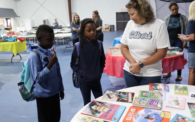 Third grader Nate Maxwell and fourth grader Anallia Aquino, both Elbert County Elementary students, choose books with the help of L4GA coordinatorThesa Beatenbough of Elbert County Schools.  (Photo by Weeks)