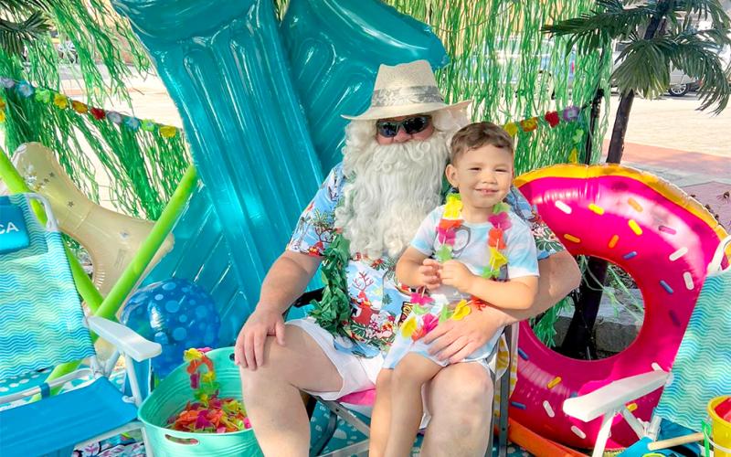 Dakota Johnson "chilled out" with Santa at Main Street's 2023 Christmas in July event on the public square.