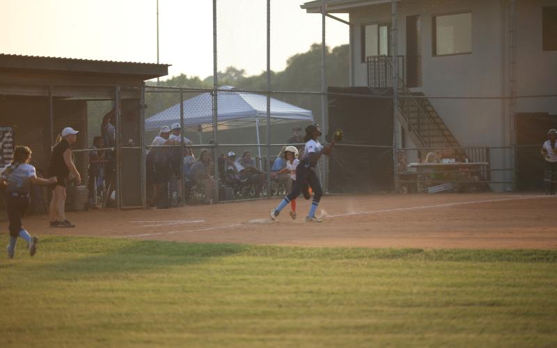 Sameria McClendon catches the ball while tagging first base to put out a runner during the 8-10-year-old Softball District 7 Championship Game against Hart June 27.  (Photo by Wells)