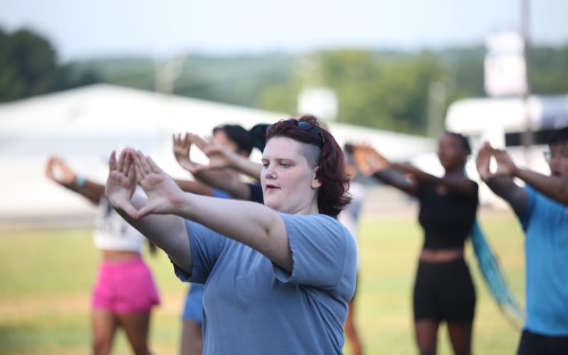 Delilah Clements simulates holding a musical instrument while marching during band camp July 16. (Photo by Wells)