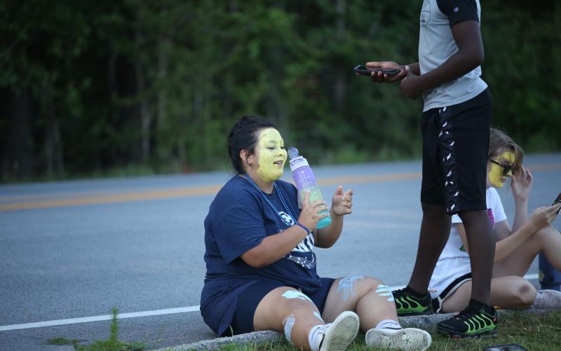 Abby Vazquez takes a drink of water in the summer heat during the Elbert County Blue Devil Band’s annual band camp. (Photo by Wells)