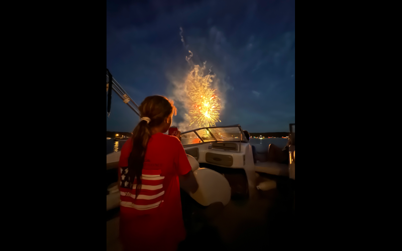 McKenzi Kesler watches the sky light up during the Soap Creek fireworks display while her dad, Larry, captures her reaction on his.