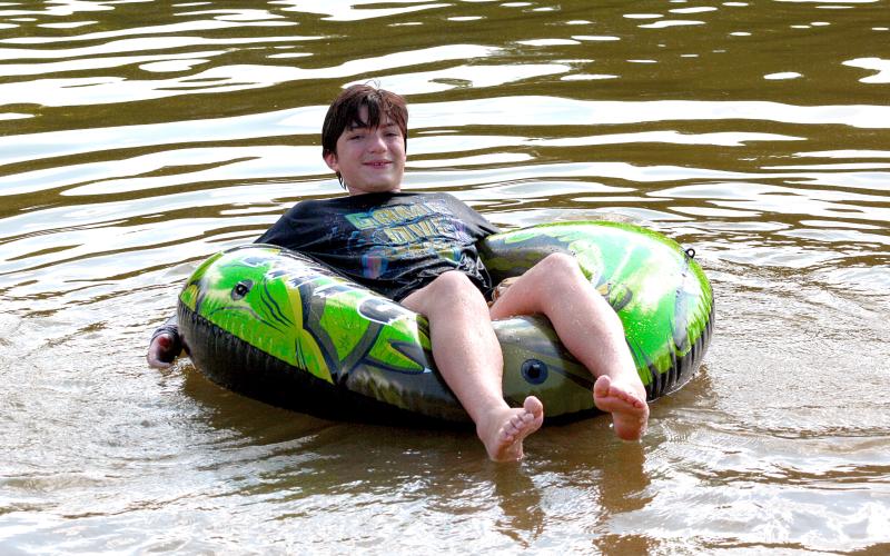 Elberton resident Asher Hanson enjoys beating the heat in the somewhat tepid lake water along with his sister, Isabelle, and their friends and family while visiting Lake Russell State Park Saturday, June 29.