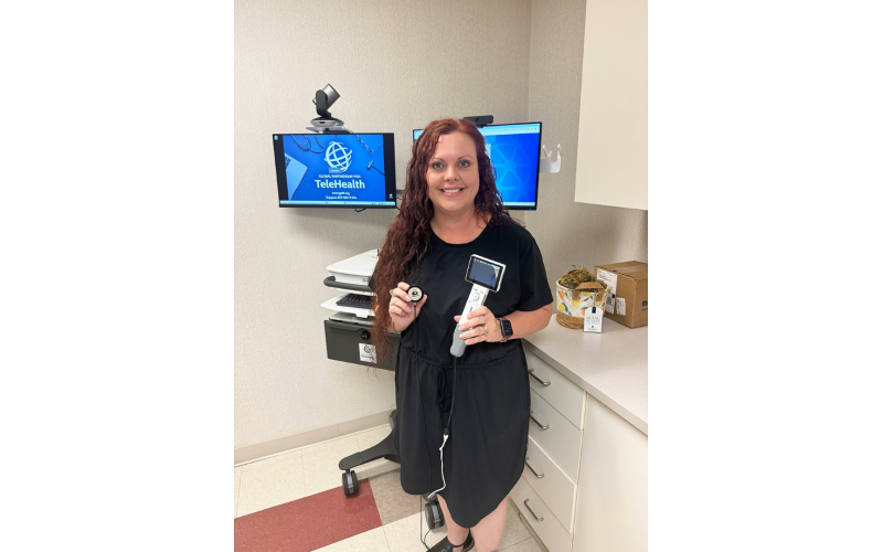 Practice Administrator Brooke McDowell displays some of the tools associated with the new pediatric telehealth cart. (Photo by Evans)