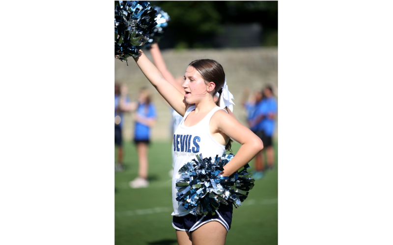 Even a heat index of over 100 degrees didn't keep the ECCHS cheerleaders from supporting the Devils at Friday's Friday Night Lights Community Kickoff event.  Freshman cheerleader Olivia Paramore cheers with her varsity cheerleading squad on the sidelines of the Granite Bowl during the Aug. 9 event. (Photo by Weeks)