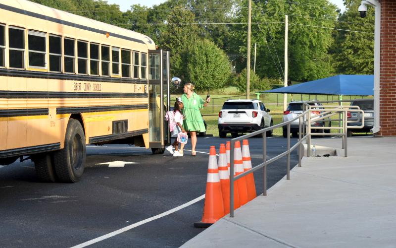 Elberton Primary School teacher Corrie Padgett helps students navigate their way from their bus to the school building. (Photo submitted by Michelle Scarborough)
