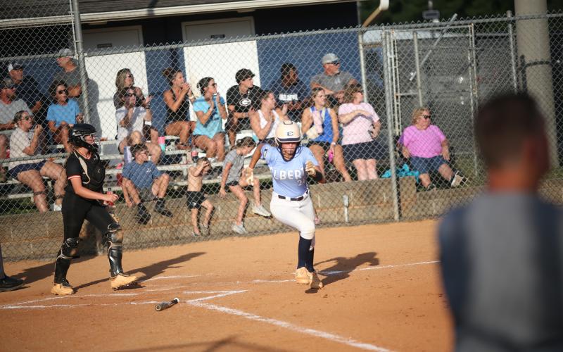 Kamryn Webb sprints out of the box after putting the ball in play.  (Photo by Wells)