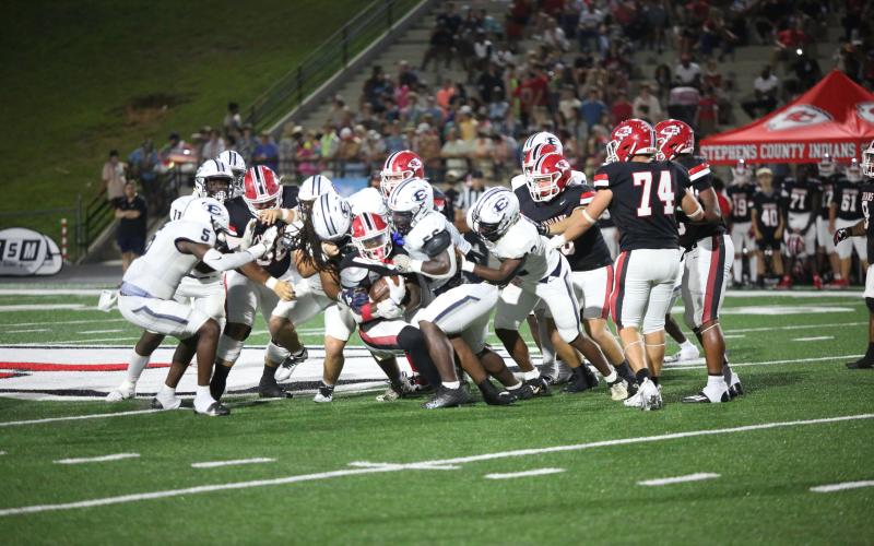 Pop Gurley, Jerrell Sims and Gilbert Fortson swarm a Stephens ballcarrier. (Photo by Wells)