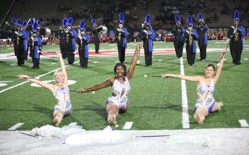 Sydney Prince, Jurnee Porter and Lila Layne pose at the end of a song during the Blue Devil Band’s halftime performance. (Photo by Wells)