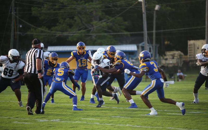 Jesean Jenkins runs through a pair of arm tacklers  during the scrimmage against the Tigers. (Photo by Wells)