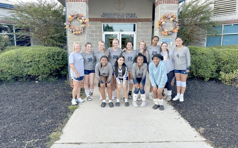 The Lady Devils volleyball team poses for a team picture outside Monsignor Donovan’s gym after winning a pair of games over the Lady Rams and George Walton Academy Sept. 19. (Photo by Wells)