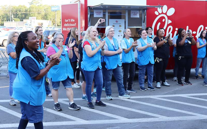 Employees participate in the Walmart cheer. (Photo by Weeks)