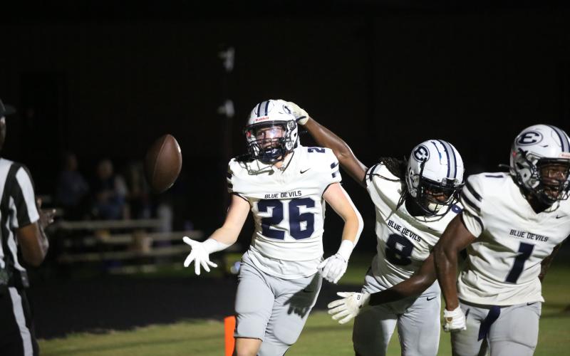 No. 26 Colson Brown smiles and celebrates with No. 8 Marion Rambert and No. 1 Ty’Rikis Jones as he tosses the ball to the referee after scoring a touchdown against Oglethorpe. (Photo by Wells)