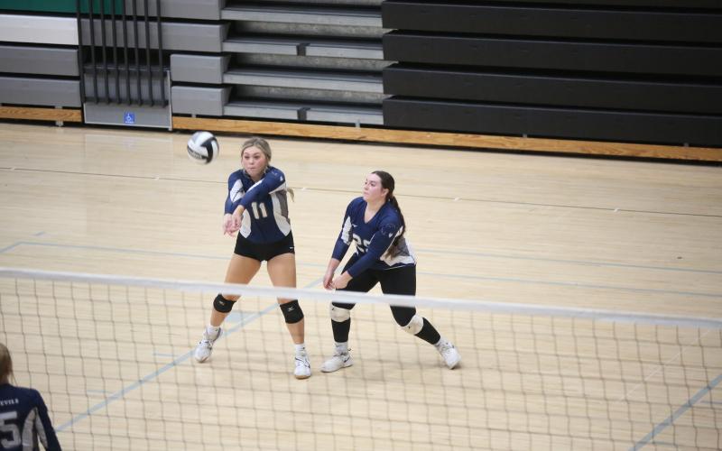 Kendall Baston bumps the ball and is backed up by Alyssa Mooney during Elbert’s match against Loganville Aug. 29.  (Photo by Wells)