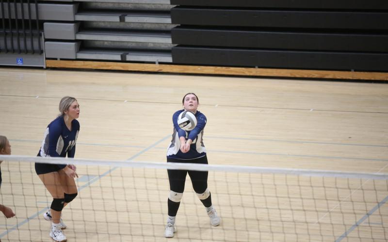 Alyssa Mooney bumps the ball back over the net. (Photo by Wells)