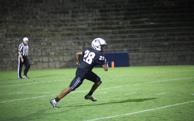 Nate Burton returns the opening kickoff in the game against Wesleyan. (Photo by Wells)