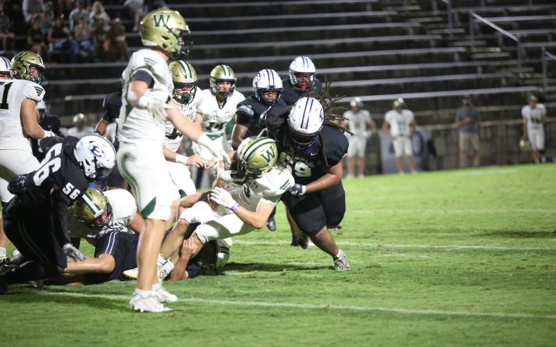 Pop Gurley hits a Wesleyan runner during Elbert’s 49-35 win over the Wolves. (Photo by Wells)