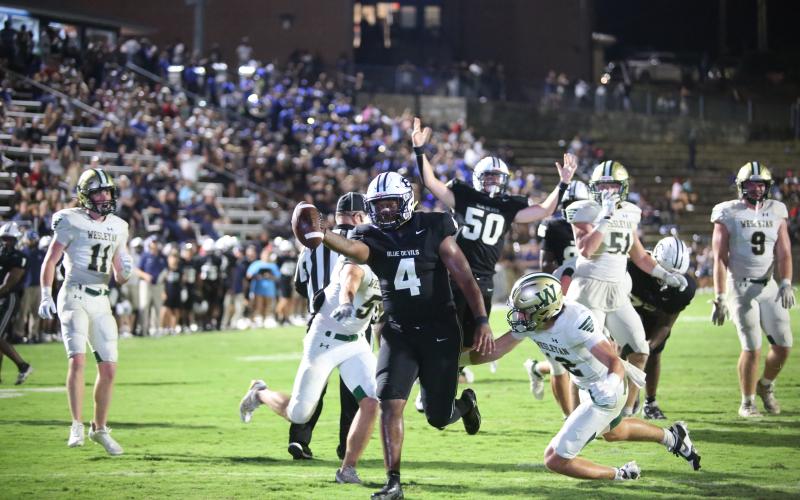 No. 4 Jayvyn Hickman extends the ball over the goal line for an Elbert touchdown late in the fourth quarter while No. 50 Landon Williams celebrates. (Photo by Wells)