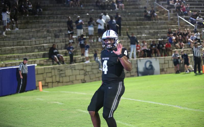 Jayvyn Hickman smiles and waves to the camera after punching in one of his three rushing touchdowns. (Photo by Wells)