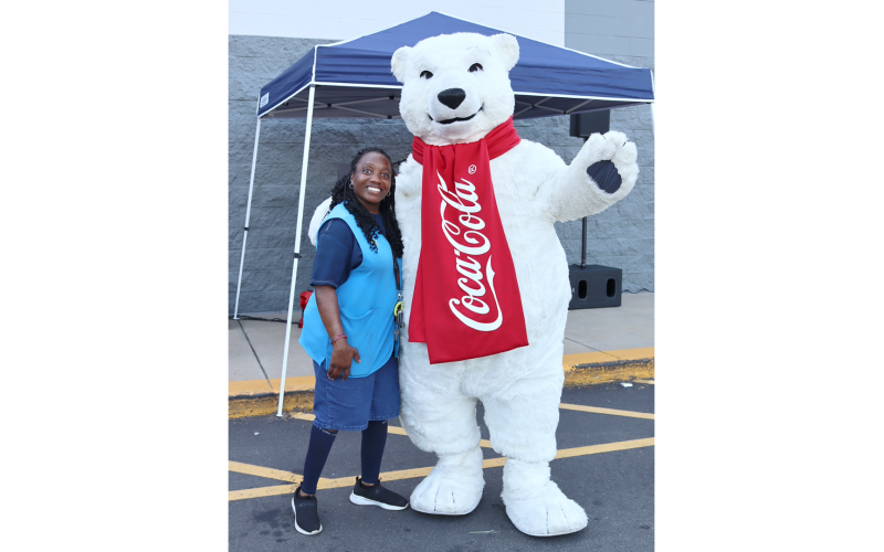 Walmart greeter Kaneka Reid stands with the Coca-Cola Bear. (Photo by Weeks)