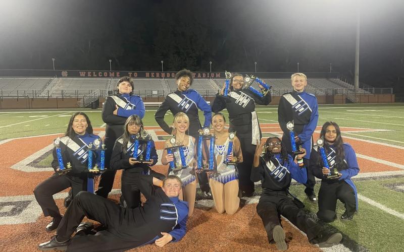 The Elbert County Blue Devil Band earned four first-place finishes and a superior rating in every category during the Lake Hartwell Marching Band Competition Oct. 19. Pictured with their collection of trophies are (front) Landon Bowman, (second row, L-R) Jocelyn Castillo, Naomi Bernal, Sydney Prince, Emily Poon, Micah Stribling, Devisha Desai and (back row, L-R) Emma Haynie, Nadia Hughes, Zuri Reid and Liam Wilder. (Photo courtesy of Elbert County Blue Devil Band)